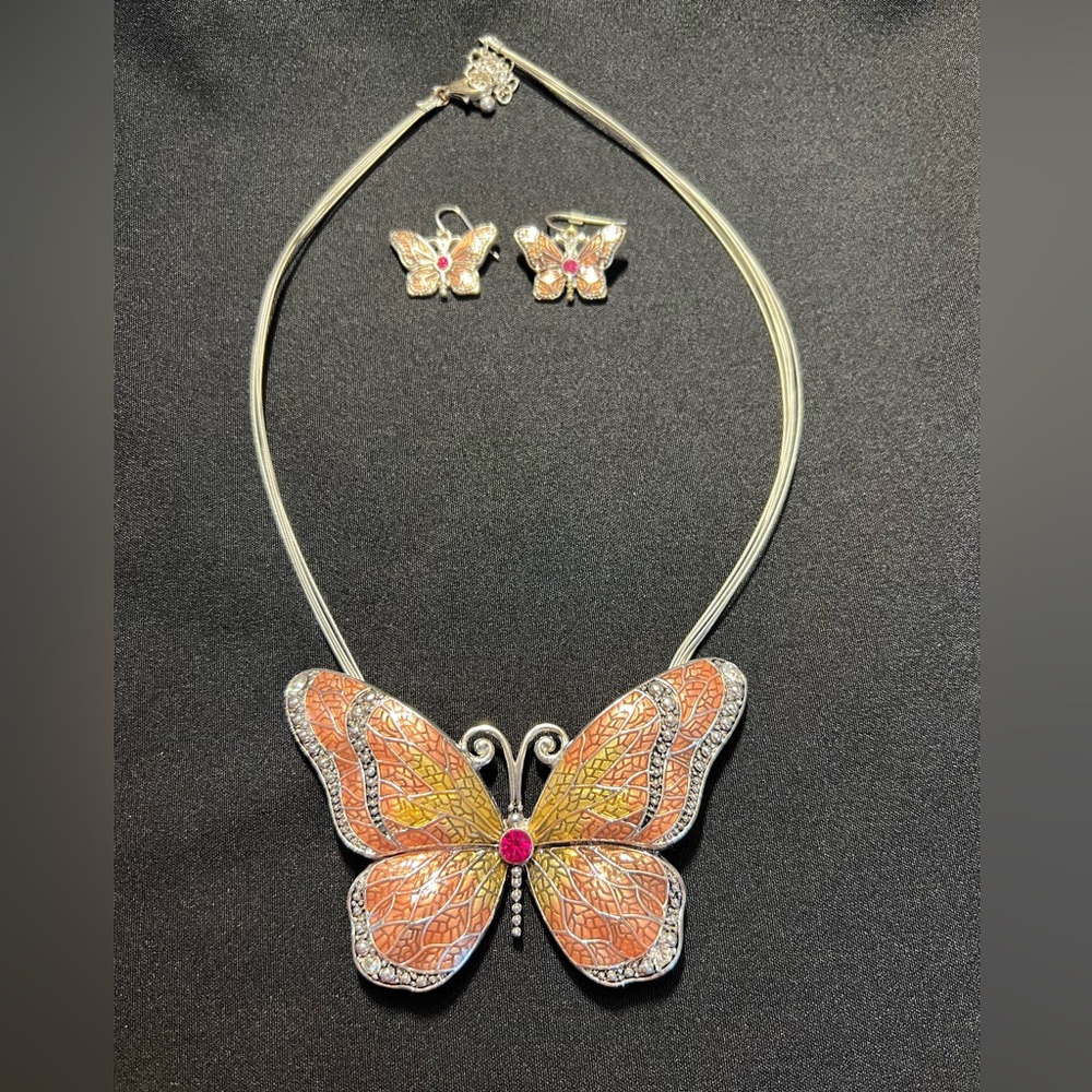 Peach, gold tone butterfly on a silver necklace with matching earrings